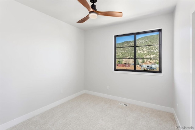 empty room with carpet flooring and ceiling fan