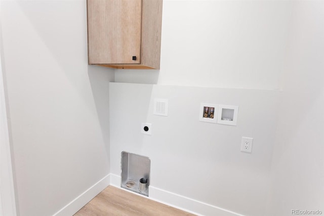 laundry room featuring light hardwood / wood-style floors, electric dryer hookup, washer hookup, and cabinets