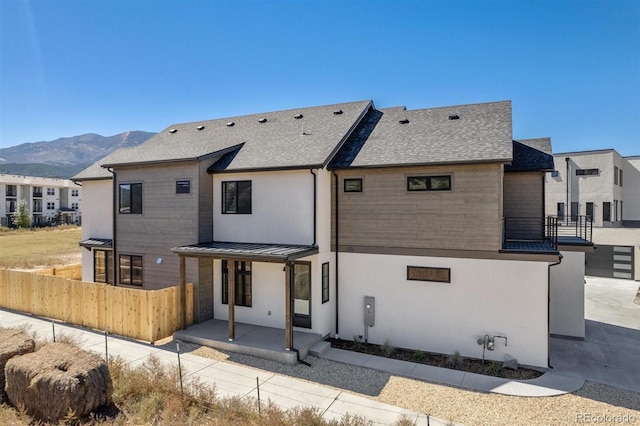 back of house with a patio and a mountain view