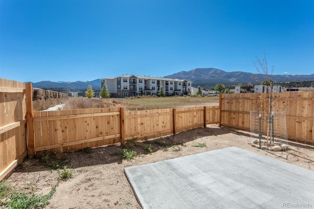 view of yard with a patio and a mountain view