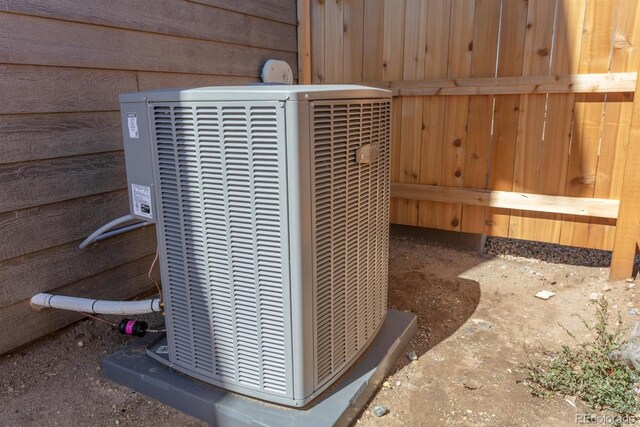 details featuring wood walls and central air condition unit