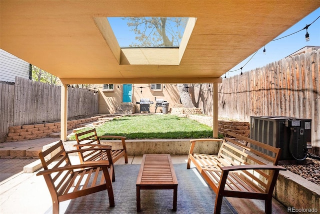 view of patio / terrace featuring central AC unit, entry steps, a fenced backyard, and an outdoor hangout area