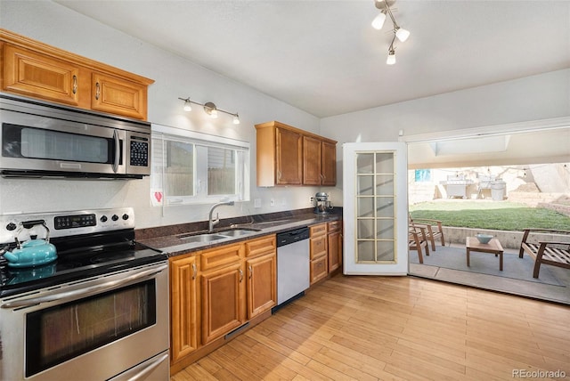 3629 Kalamath St, Denver, CO 80211 - kitchen featuring appliances with stainless steel finishes, a sink, and brown cabinetry