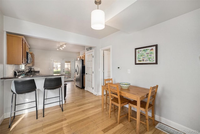 3629 Kalamath St, Denver, CO 80211 - dining space with french doors, light wood-style flooring, and baseboards
