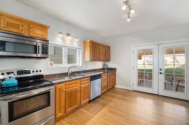 3629 Kalamath St, Denver, CO 80211 - kitchen featuring appliances with stainless steel finishes, a sink, healthy amount of natural light, and french doors