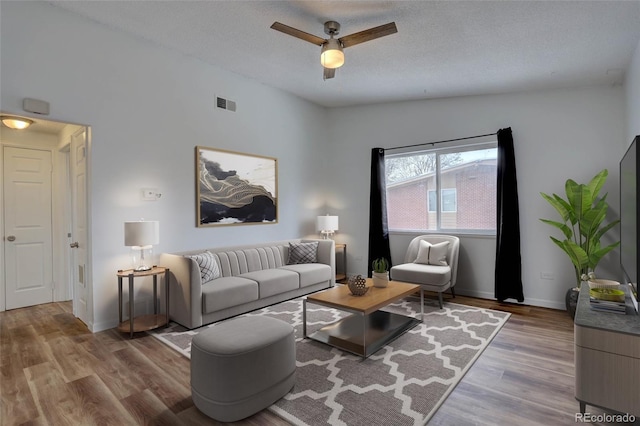 2938 Eliot Cir, Westminster, CO 80030 - living area featuring wood finished floors, ceiling fan, a textured ceiling, and baseboards