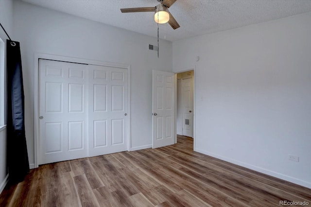 2938 Eliot Cir, Westminster, CO 80030 - unfurnished bedroom featuring a textured ceiling, wood finished floors, a closet, baseboards, and ceiling fan