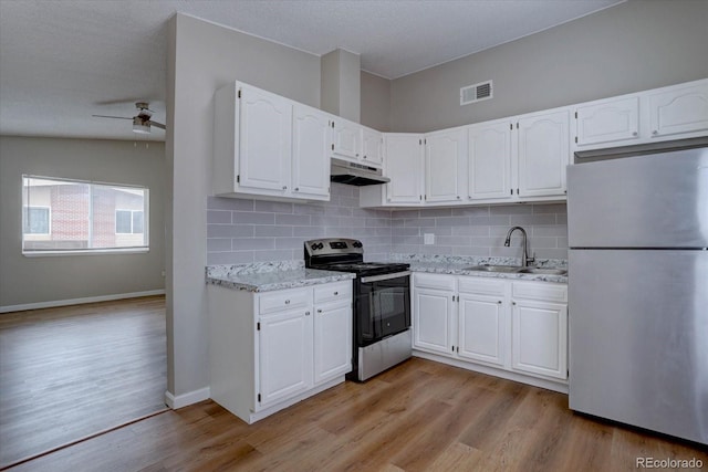 2938 Eliot Cir, Westminster, CO 80030 - kitchen featuring stainless steel appliances, a sink, under cabinet range hood, white cabinetry, and a ceiling fan