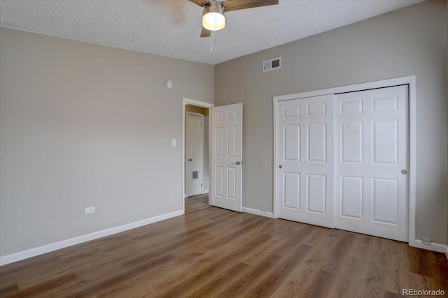2938 Eliot Cir, Westminster, CO 80030 - unfurnished bedroom with wood finished floors, baseboards, a textured ceiling, a closet, and lofted ceiling