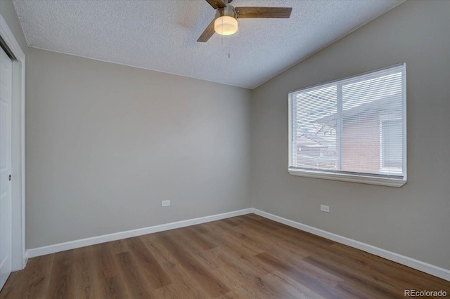 2938 Eliot Cir, Westminster, CO 80030 - empty room with a textured ceiling, wood finished floors, vaulted ceiling, ceiling fan, and baseboards