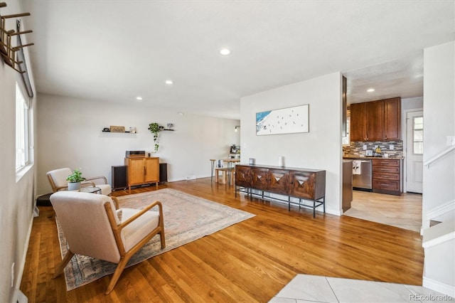living room with recessed lighting, baseboards, and light wood-style floors