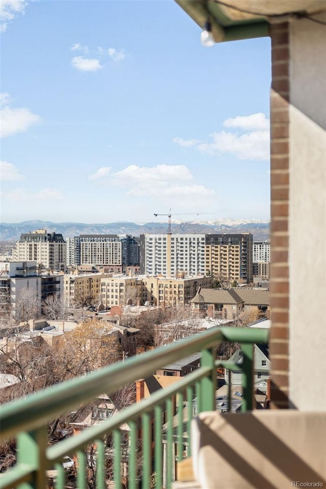 balcony featuring a mountain view and a city view