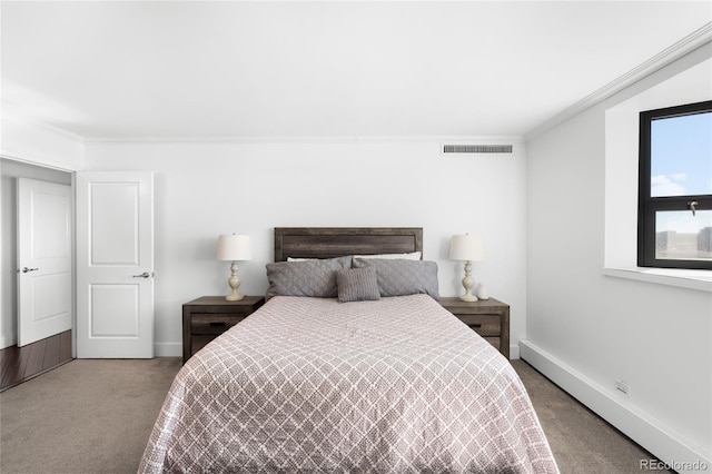 carpeted bedroom with baseboards, visible vents, and ornamental molding