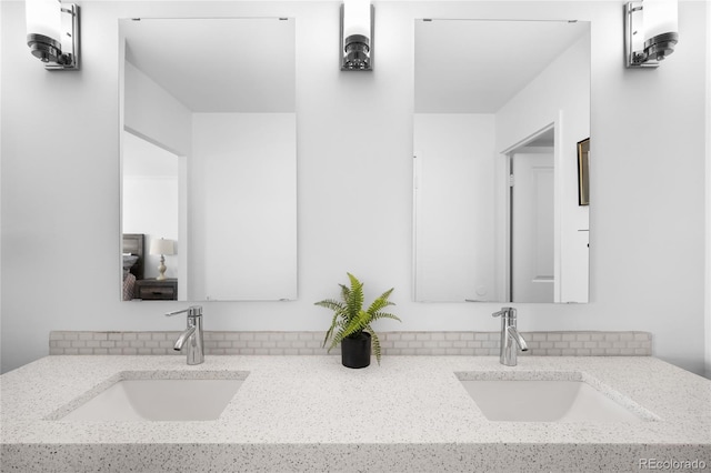 full bathroom featuring double vanity and a sink