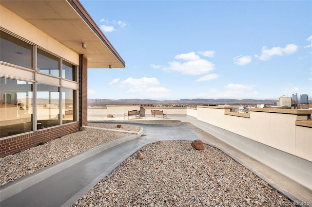 view of yard featuring a patio and a mountain view