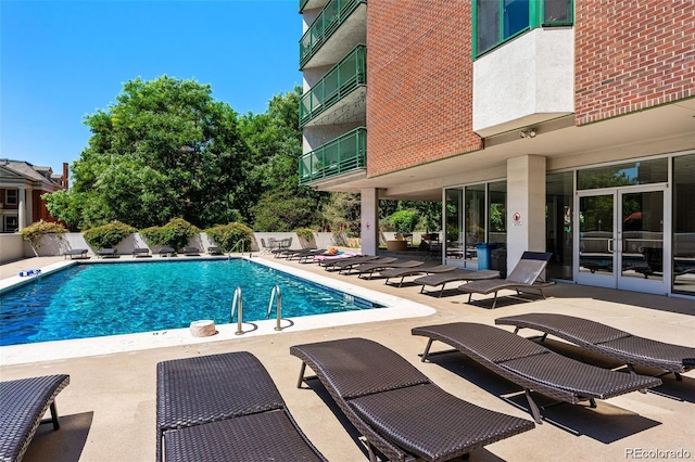 community pool featuring a patio area and fence