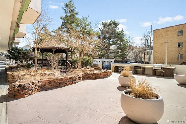 view of patio / terrace with exterior kitchen, central AC, and a gazebo