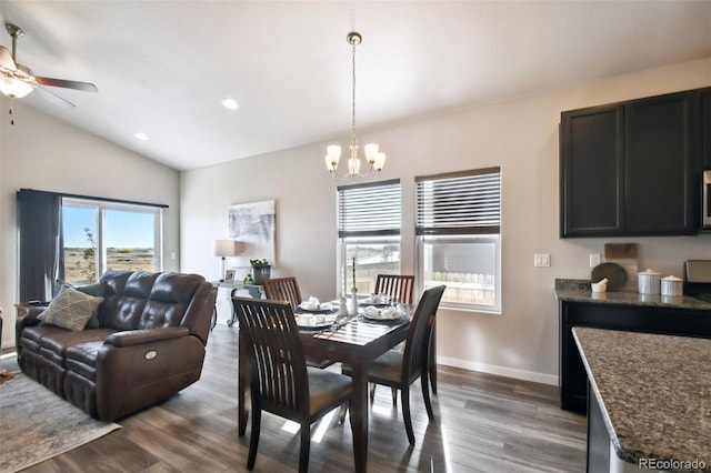 dining room featuring lofted ceiling, dark hardwood / wood-style floors, and ceiling fan with notable chandelier