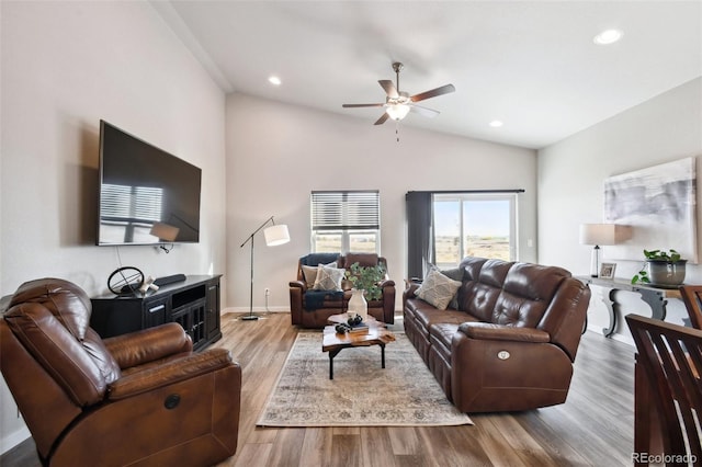 living room featuring lofted ceiling, light hardwood / wood-style floors, and ceiling fan