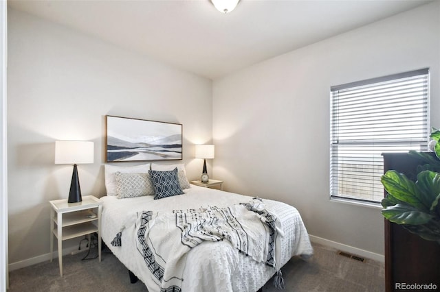 bedroom featuring dark carpet