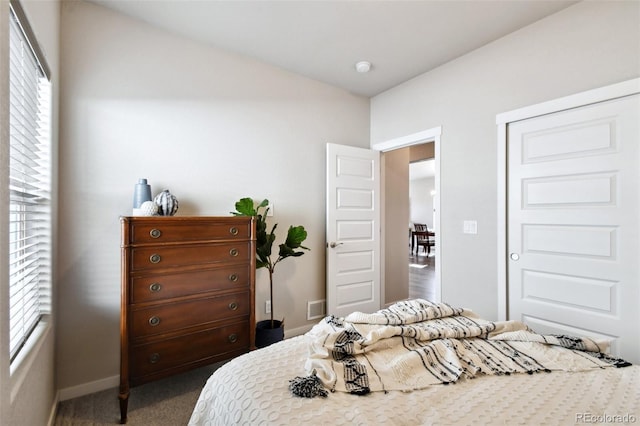 carpeted bedroom featuring lofted ceiling and multiple windows