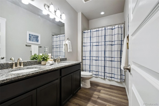 bathroom featuring vanity, hardwood / wood-style floors, and toilet