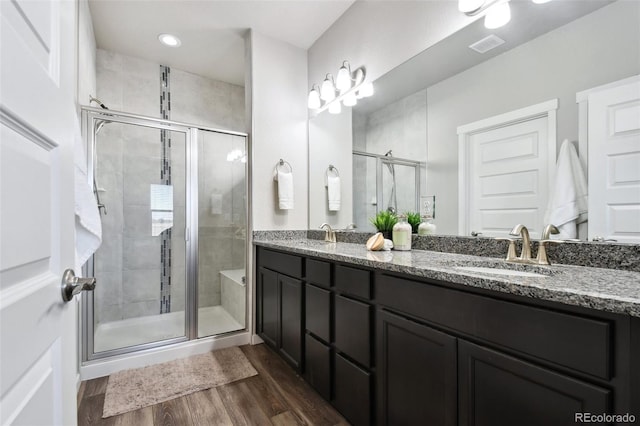 bathroom featuring vanity, hardwood / wood-style floors, and walk in shower