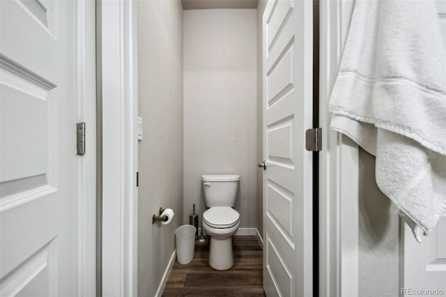 bathroom with hardwood / wood-style flooring and toilet