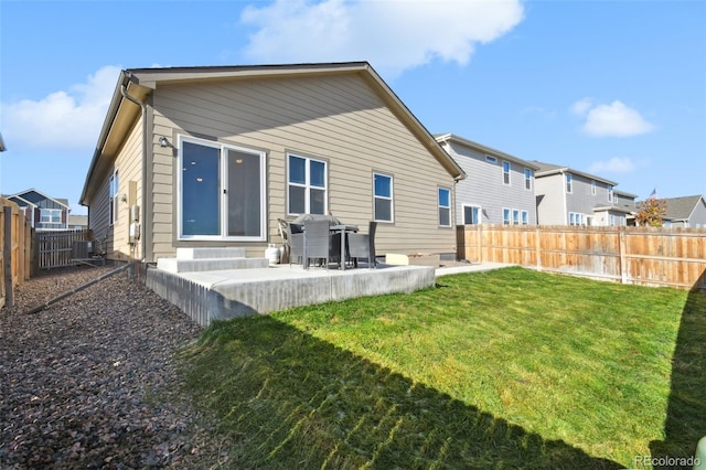 rear view of house with a patio, central AC unit, and a lawn