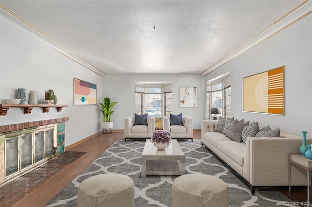 living room featuring a brick fireplace and hardwood / wood-style floors