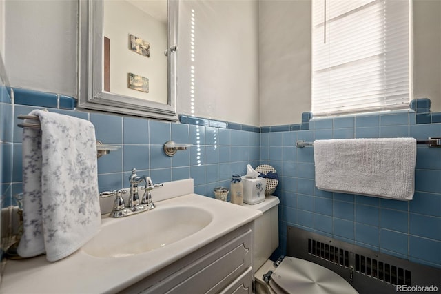 bathroom featuring radiator heating unit, tile walls, and vanity