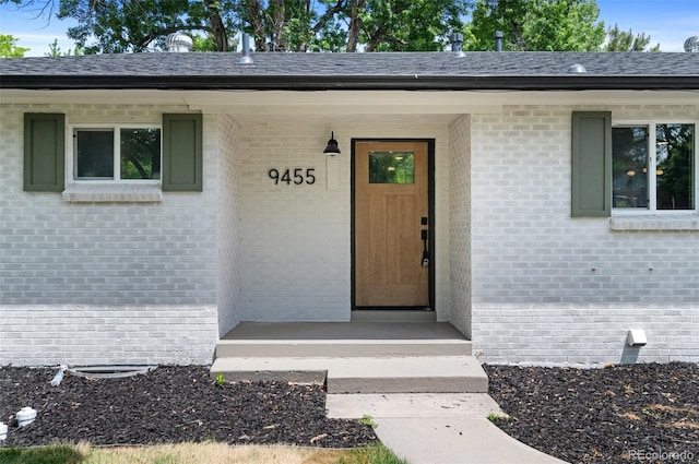 9455 W 37th Ave, Wheat Ridge, CO 80033 - doorway to property with brick siding and covered porch