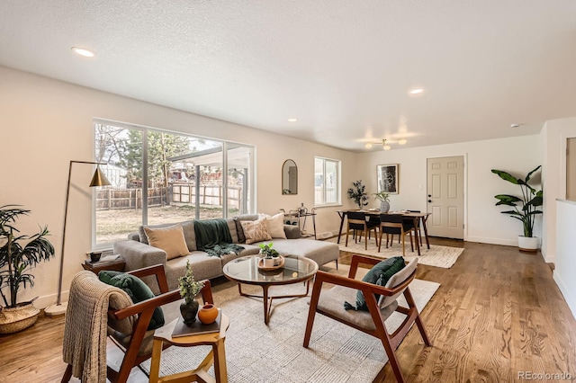 9455 W 37th Ave, Wheat Ridge, CO 80033 - living area featuring wood finished floors, plenty of natural light, recessed lighting, and baseboards