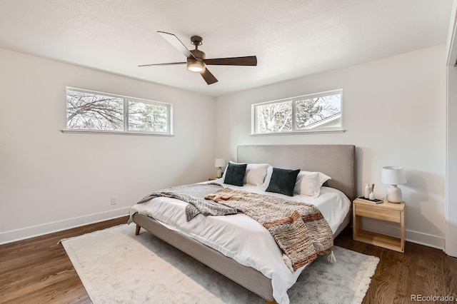 9455 W 37th Ave, Wheat Ridge, CO 80033 - bedroom featuring multiple windows, baseboards, and wood finished floors