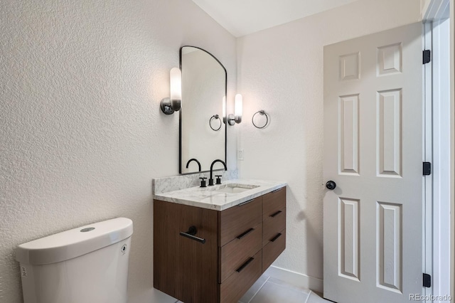 9455 W 37th Ave, Wheat Ridge, CO 80033 - half bathroom featuring vanity, toilet, and tile patterned flooring