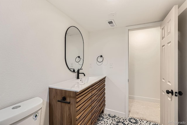 9455 W 37th Ave, Wheat Ridge, CO 80033 - bathroom with vanity, toilet, baseboards, and tile patterned flooring