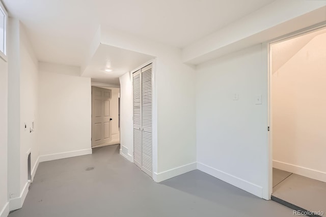 9455 W 37th Ave, Wheat Ridge, CO 80033 - unfurnished bedroom featuring a closet, concrete floors, and baseboards