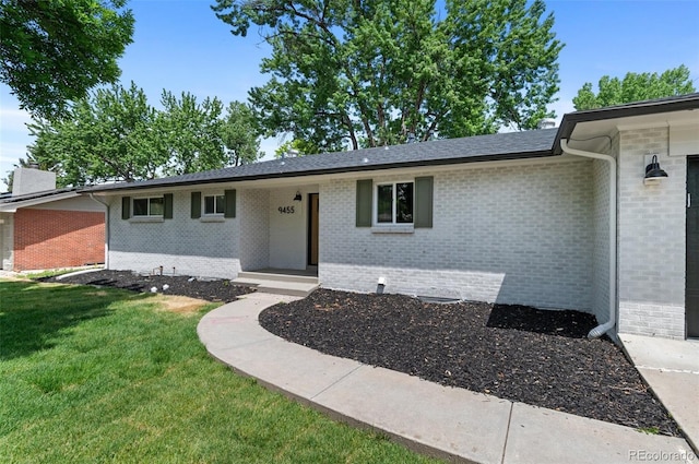 9455 W 37th Ave, Wheat Ridge, CO 80033 - view of front facade with a front lawn and brick siding