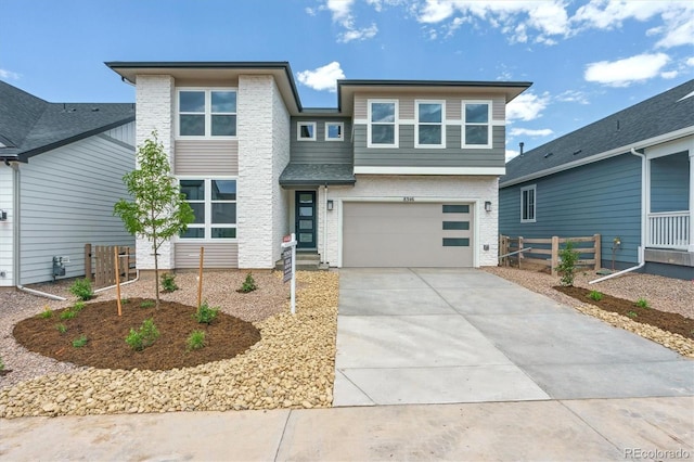 8346 Cokedale Cir, Littleton, CO 80125 - view of front of house featuring driveway, brick siding, and a garage