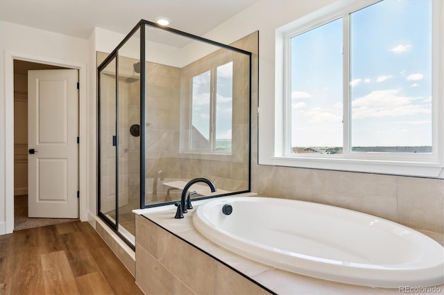 8346 Cokedale Cir, Littleton, CO 80125 - bathroom with a bath, a stall shower, and wood finished floors