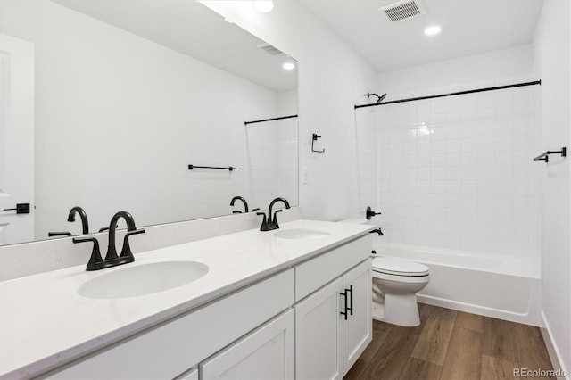 8346 Cokedale Cir, Littleton, CO 80125 - bathroom featuring wood finished floors, double vanity, shower / bathtub combination, and recessed lighting