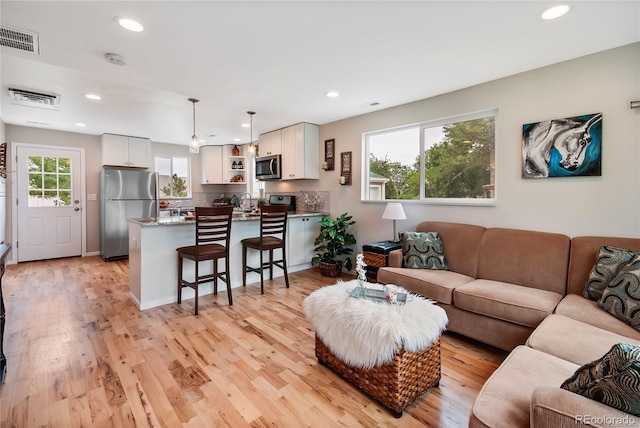 6245 W 53rd Ave, Arvada, CO 80002 - living room featuring recessed lighting and light wood-style floors