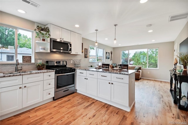 6245 W 53rd Ave, Arvada, CO 80002 - kitchen featuring stainless steel appliances, a sink, a peninsula, light wood-style flooring, and recessed lighting