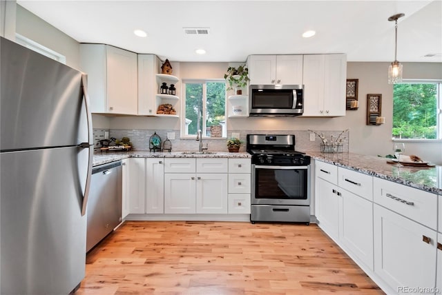 6245 W 53rd Ave, Arvada, CO 80002 - kitchen with appliances with stainless steel finishes, open shelves, plenty of natural light, a sink, and recessed lighting