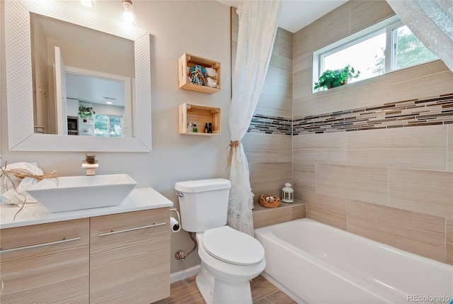 6245 W 53rd Ave, Arvada, CO 80002 - full bath featuring toilet, shower / tub combo, vanity, wood finished floors, and baseboards