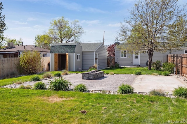 6245 W 53rd Ave, Arvada, CO 80002 - rear view of property with a fire pit, an outdoor structure, a patio, and roof with shingles