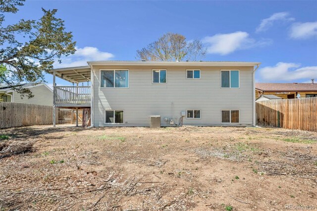 3516 Marigold St, Evans, CO 80620 - rear view of house with a fenced backyard, central AC unit, and a wooden deck