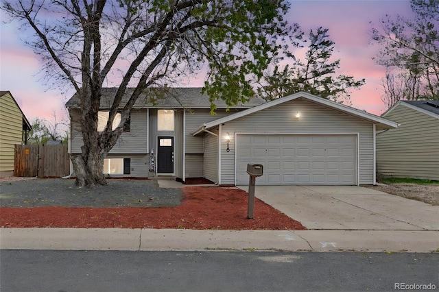3516 Marigold St, Evans, CO 80620 - view of front of house with a garage, fence, and driveway
