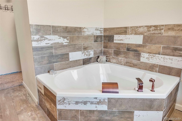 3516 Marigold St, Evans, CO 80620 - bathroom featuring wood finished floors and a garden tub