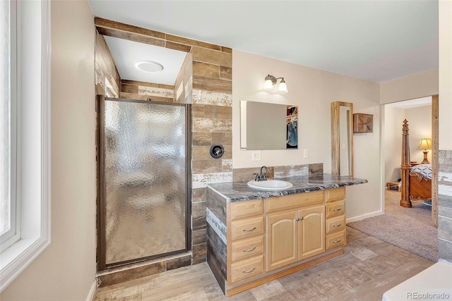 3516 Marigold St, Evans, CO 80620 - full bathroom with vanity, connected bathroom, wood finished floors, and a shower stall